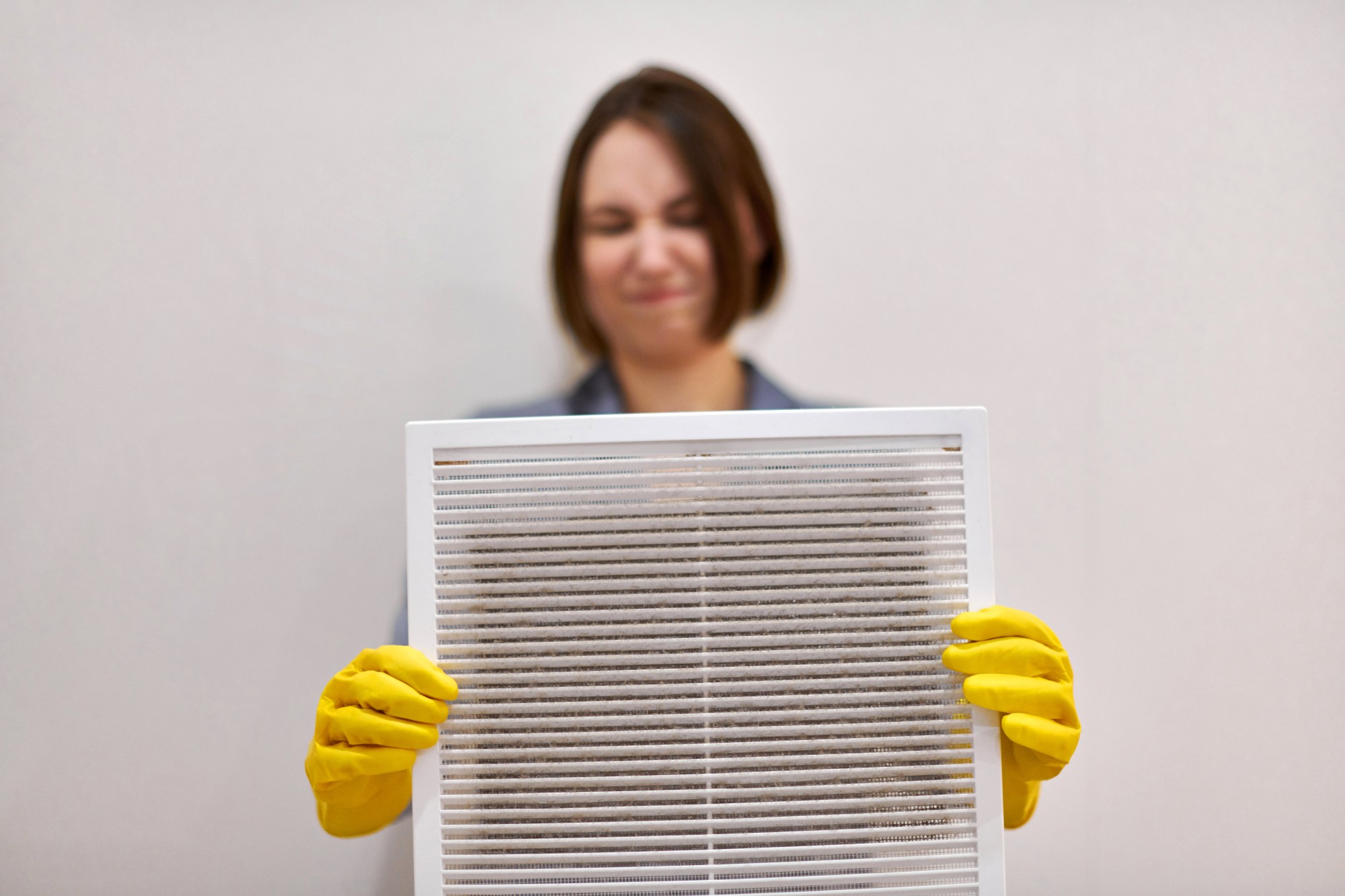 woman holding Indoor air pollutants filled an AC screen
